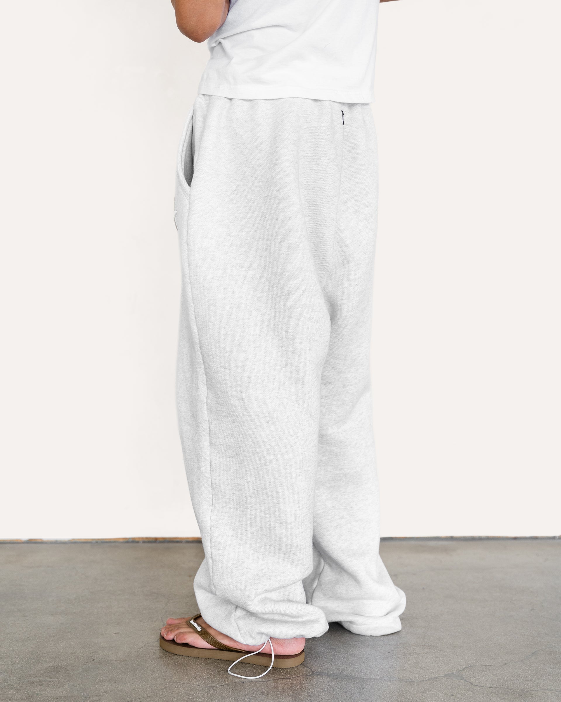 Model wearing heather grey sweatpants, back view — Sand Castle Atelier