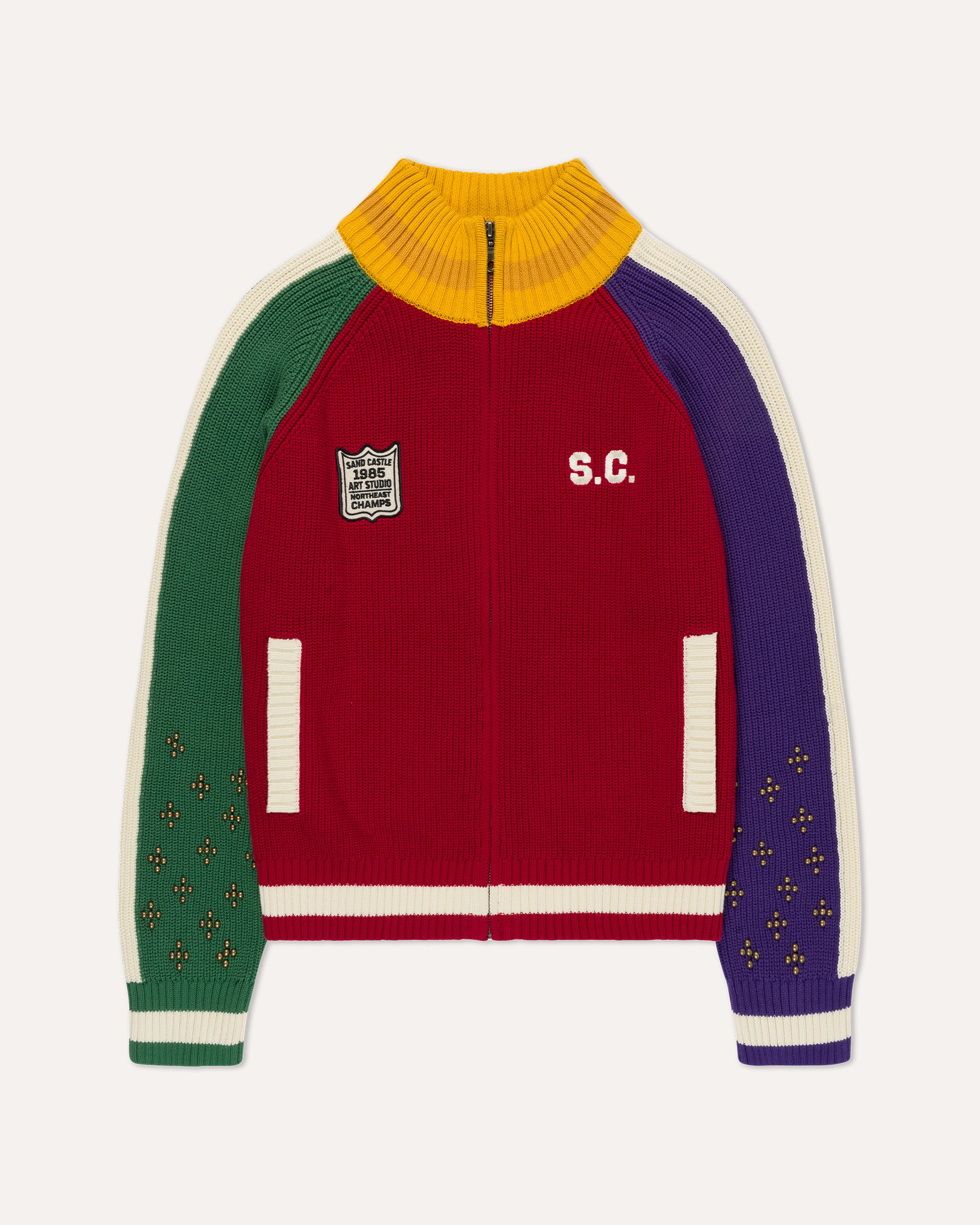 A multicolor ribbed knit zip-up track jacket with a yellow mock neck, green right sleeve, purple left sleeve, and cream stripes, featuring 'S.C.