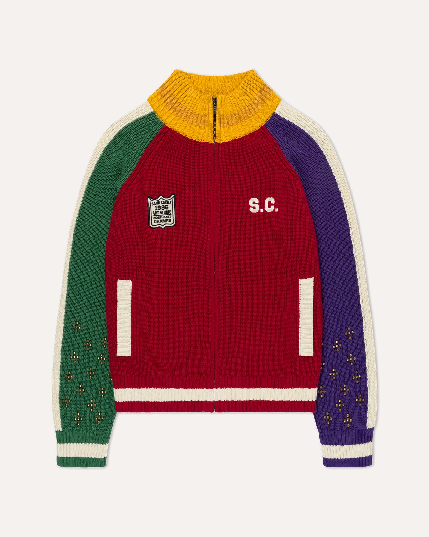 A multicolor ribbed knit zip-up track jacket with a yellow mock neck, green right sleeve, purple left sleeve, and cream stripes, featuring 'S.C.