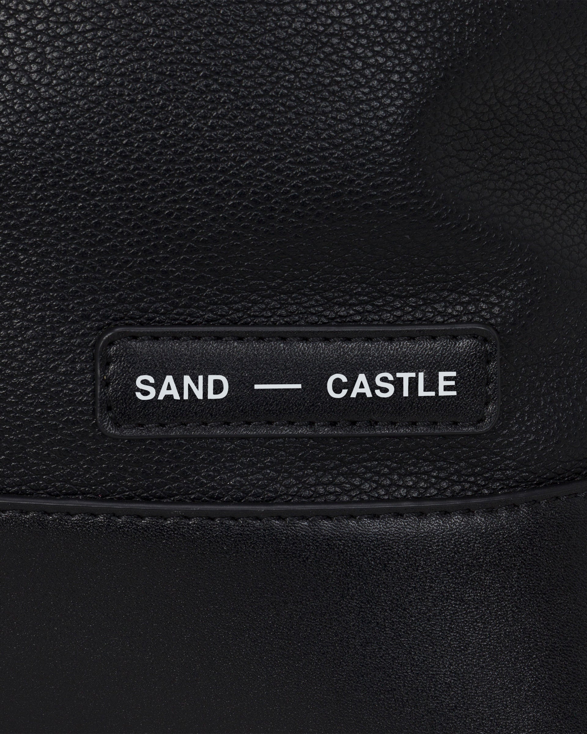 Sand Castle Atelier branded tag detail on Atelier Bag in Coal